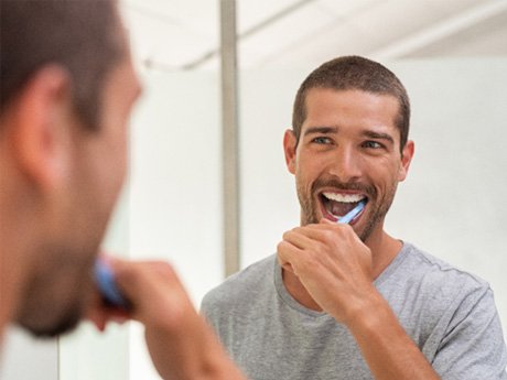 man brushing his teeth