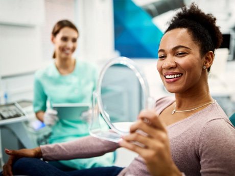 smiling woman sitting in a dental office