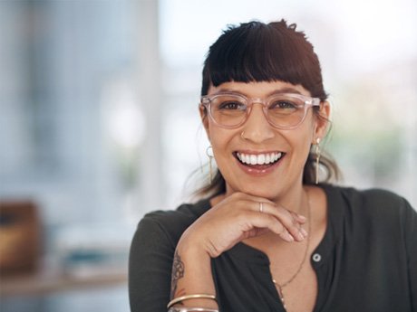 woman with glasses smiling